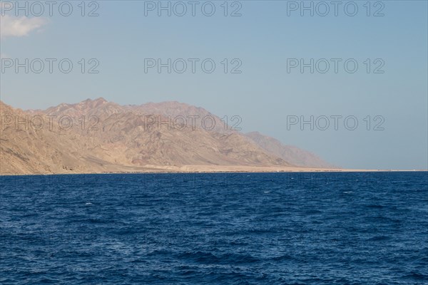 The coastline of the Red Sea and the mountains in the background. Egypt, the Sinai Peninsula, Dahab