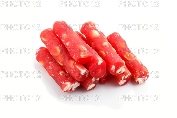 Red traditional turkish delight (rahat lokum) with peanuts isolated on white background. side view, close up