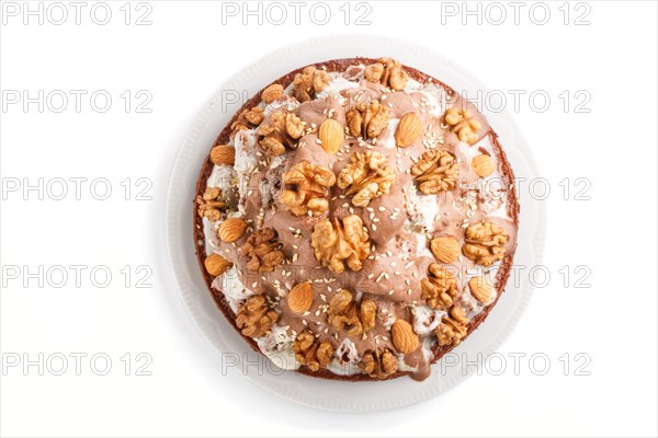 Homemade cake with milk cream, cocoa, almond, hazelnut isolated on white background. Top view, flat lay, close up