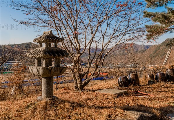 Korean concrete spirit house in shape of three story pagoda in rural countryside in South Korea