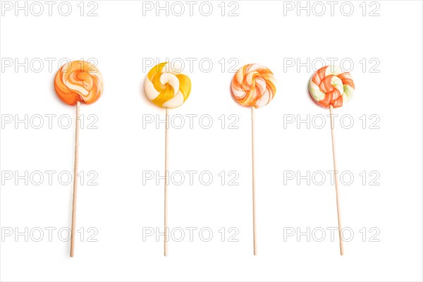 Four lollipop candies isolated on white background. close up, top view, flat lay