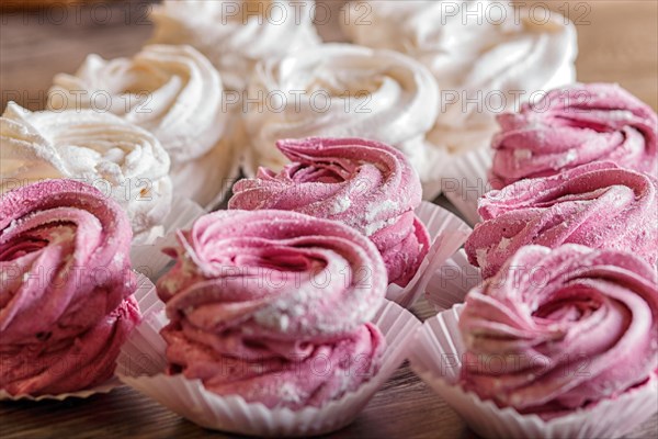 Pink and white homemade marshmallows on a gray wooden background. selective focus