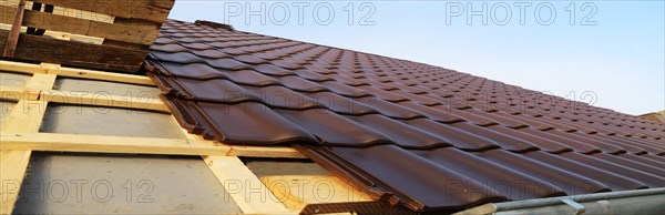 Panoramic image of the roof covering of a new tiled roof on a residential building