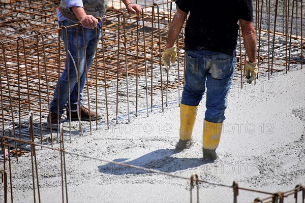 Concreting a floor slab with ready-mixed concrete on the construction site of a residential building