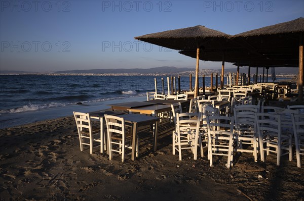 Tables, chairs, stacked, parasols, beach bar, empty, beach, sea, Peraia, also Perea, evening light, Thessaloniki, Macedonia, Greece, Europe