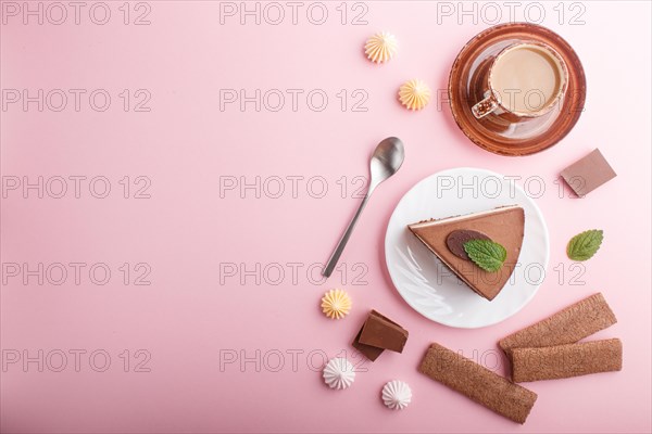 Cake with souffle milk chocolate cream with cup of coffee, meringues on a pink pastel background. top view, flat lay, copy space. breakfast concept