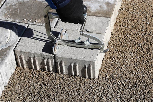 Workers lay paving stones