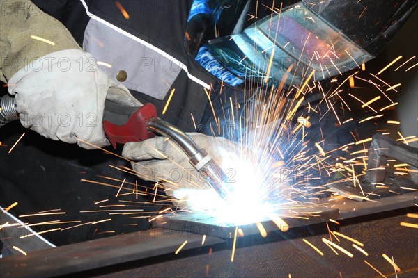 Metalworker during welding work in his workshop