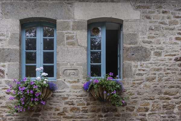 Two windows in a typical granite house, floral decoration, Dinan old town, Brittany, France, Europe