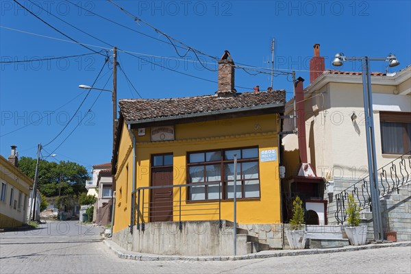 Small house with orange-painted facade and wooden windows on a quiet street, Soufli, Eastern Macedonia and Thrace, Greece, Europe