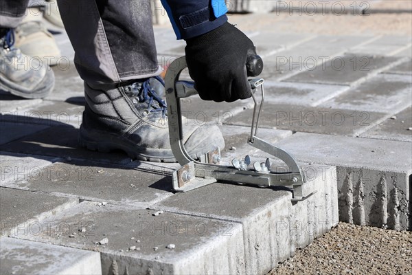 Workers lay paving stones