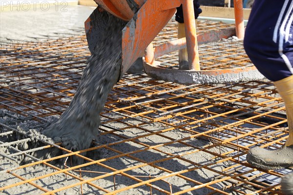 Concreting a floor slab with ready-mixed concrete on the construction site of a residential building