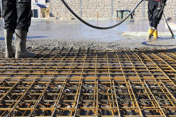 Concreting a floor slab with ready-mixed concrete on the construction site of a residential building