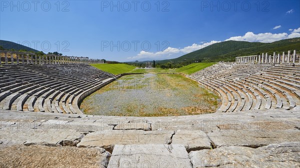 Empty ancient stadium with rows of seats in front of a hilly landscape, archaeological site, Ancient Messene, capital of Messinia, Messini, Peloponnese, Greece, Europe