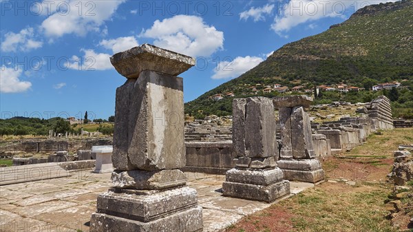 Ancient stone columns under a clear blue sky, surrounded by grass, Archaeological site, Ancient Messene, Capital of Messinia, Messini, Peloponnese, Greece, Europe