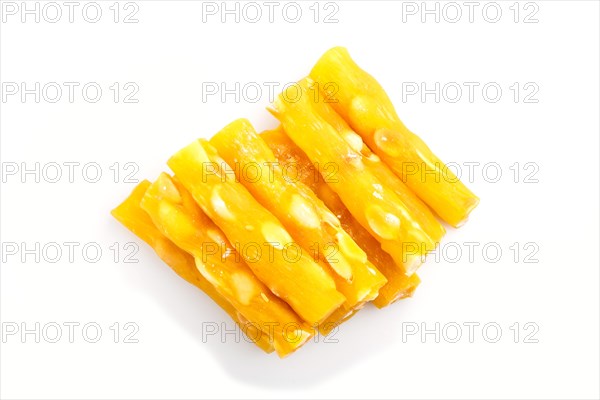 Yellow traditional turkish delight (rahat lokum) with peanuts isolated on white background. top view, flat lay, close up