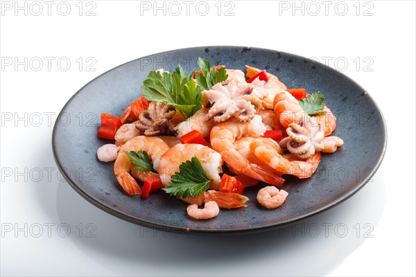 Boiled shrimps or prawns and small octopuses with herbs on a blue ceramic plate isolated on white background. side view, close up