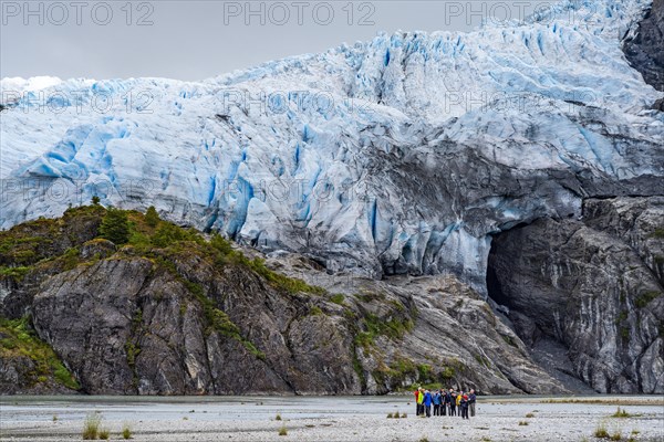 Passengers of the cruise ship Stella Australis stand at the foot of the Aguila Glacier, Alberto de Agostini National Park, Avenue of the Glaciers, Chilean Arctic, Patagonia, Chile, South America