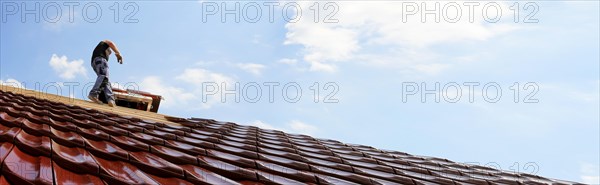 Panoramic image of the roof covering of a new tiled roof on a residential building