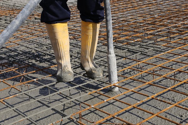 Concreting a floor slab with ready-mixed concrete on the construction site of a residential building