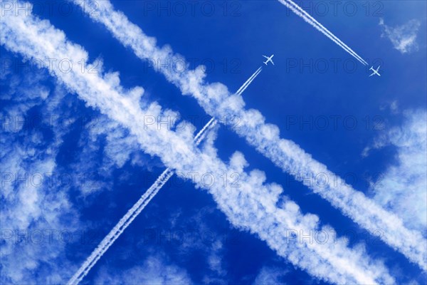Vapor trails and passenger jets high in the sky