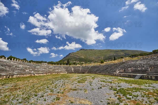 Ancient stadium with many rows of seats, surrounded by grass and sky, Archaeological site, Ancient Messene, Capital of Messinia, Messini, Peloponnese, Greece, Europe