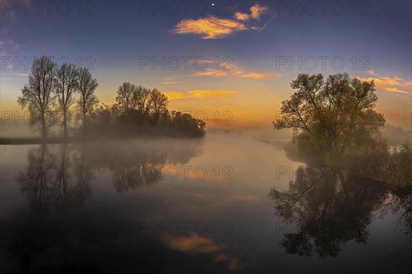 A beautiful foggy autumn morning on the Ruhr near Iserlohn. Photographed from Schoof's bridge as a long exposure. Pink clouds and a great reflection in the water