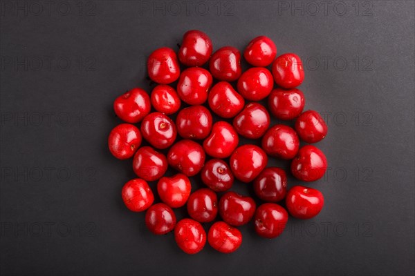 Cherries on black background, top view, flat lay, close up