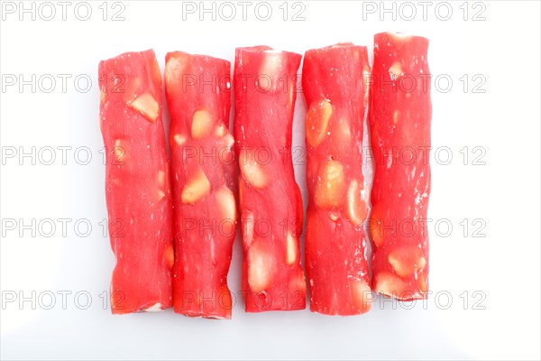Red traditional turkish delight (rahat lokum) with peanuts isolated on white background. top view, flat lay, close up