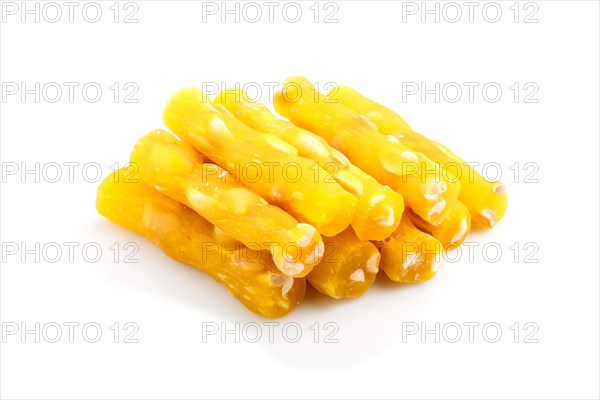 Yellow traditional turkish delight (rahat lokum) with peanuts isolated on white background. side view, close up