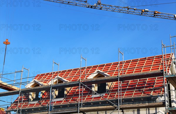 New construction of a multi-family house. The roof is currently being tiled