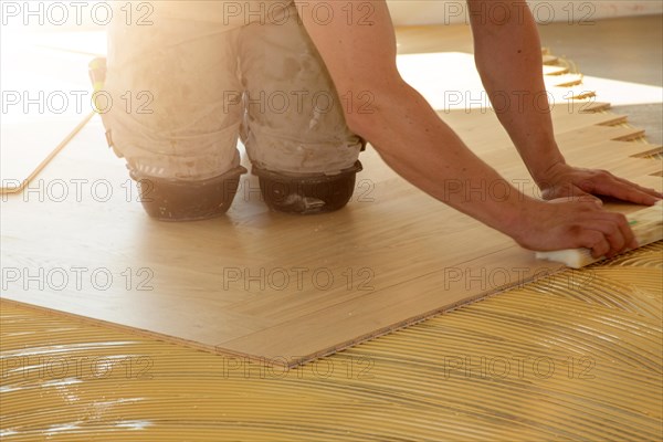 Craftsmen laying herringbone parquet professionally