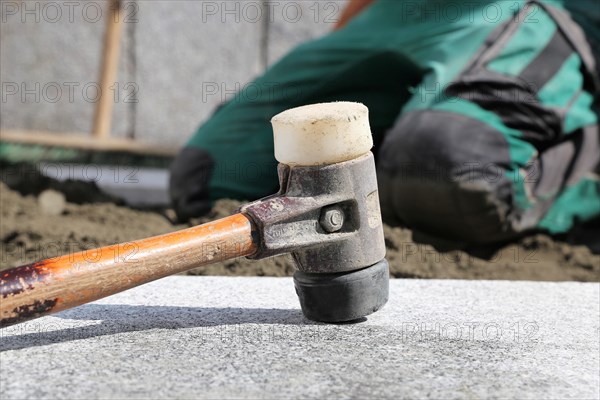 Worker lays paving stones