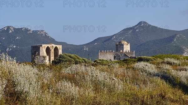 Historic ruin in a rural area with hills and blue sky in the background, sea fortress Methoni, Peloponnese, Greece, Europe