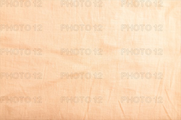 Fragment of smooth orange linen tissue. Top view, flat lay, natural textile background and texture