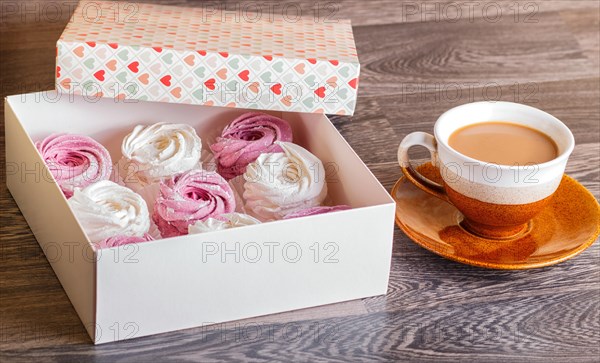 Pink and white homemade marshmallows (zephyr) with cup of coffee on a gray wooden background