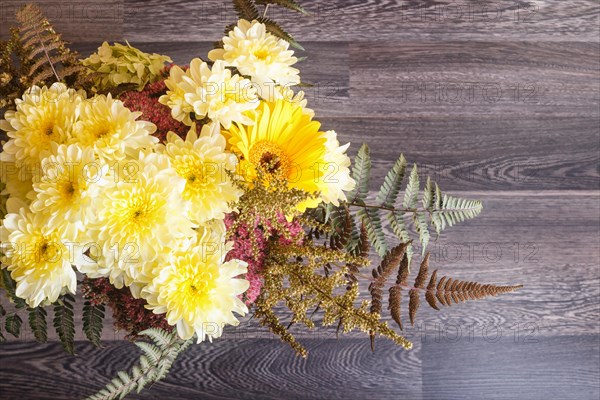 Bouquet of gerbera and chrysanthemum on a wooden background. floristic composition. copy space