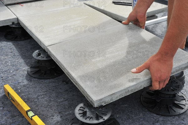 Worker lays paving stones