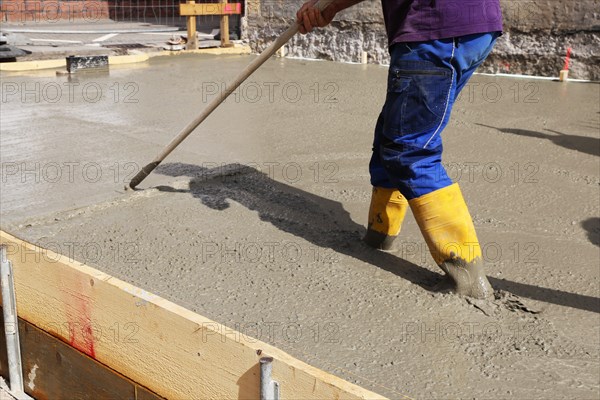 Concreting a floor slab with ready-mixed concrete on the construction site of a residential building