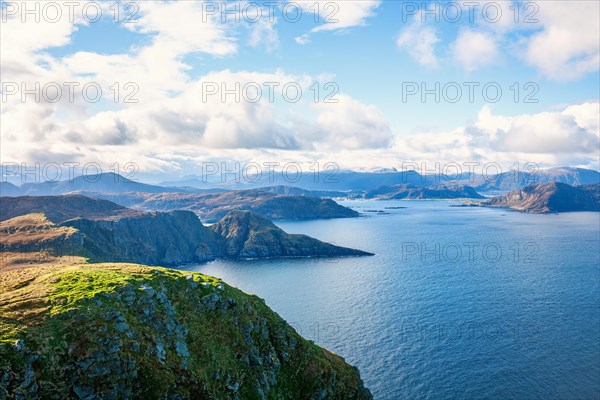 View of a fjord landscape with a rocky coast on the Norwegian coast, Runde, Heroy, Norway, Europe