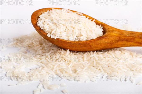 Pile of basmati rice in a wooden spoon isolated on white background