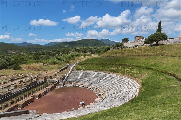 Ancient amphitheatre with rows of seats on a green meadow surrounded by hills, Ancient theatre, Archaeological site, Ancient Messene, Capital of Messinia, Messini, Peloponnese, Greece, Europe