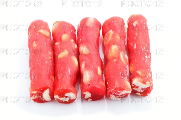 Red traditional turkish delight (rahat lokum) with peanuts isolated on white background. side view, close up