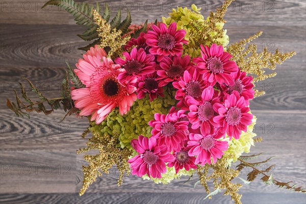 Bouquet of gerbera and chrysanthemum on a wooden background. floristic composition