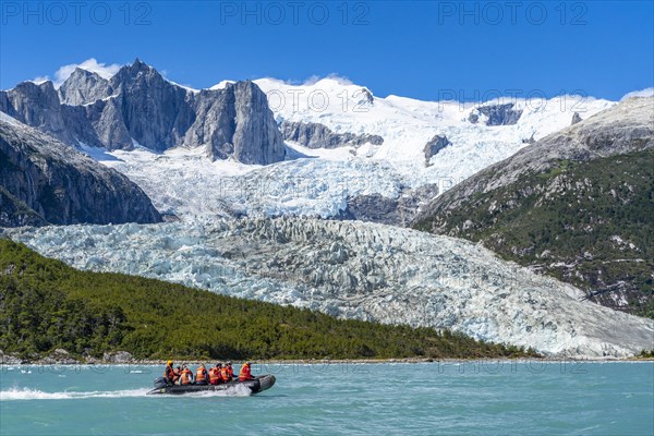 Passengers of the cruise ship Stella Australis travelling in a rubber dinghy in front of the Pia Glacier, Alberto de Agostini National Park, Avenue of the Glaciers, Chilean Arctic, Patagonia, Chile, South America