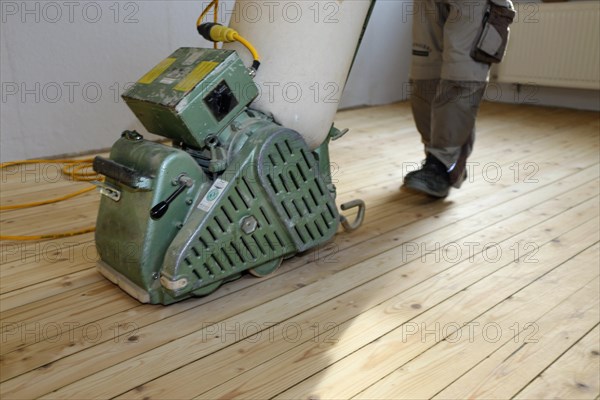 A parquet floor is sanded and oiled