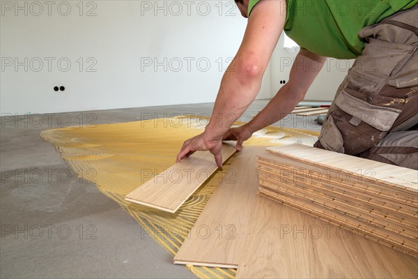 Craftsmen laying herringbone parquet professionally