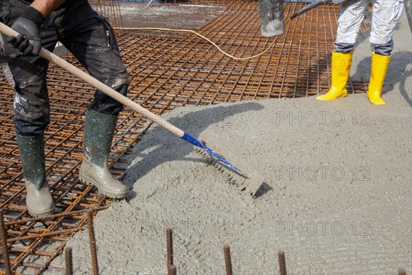 Delivery of ready-mixed concrete to the construction site of a residential building in a new development area in Mutterstadt, Palatinate
