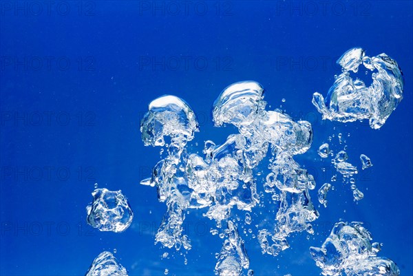 Bright Air bubbles, blue background in an aquarium