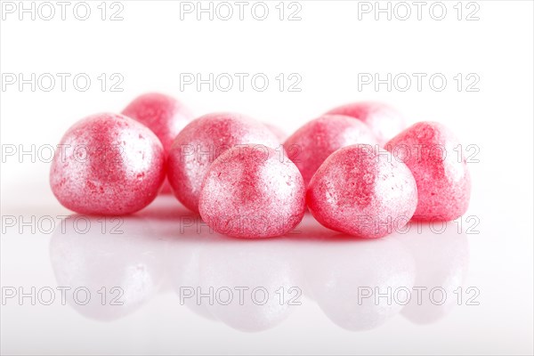 Heap of pink hard sugar candies isolated on white background